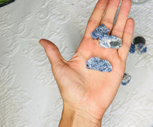 Load image into Gallery viewer, May include: A hand holding several small, rough, blue and white stones. The stones are irregularly shaped and have a natural, unpolished look.