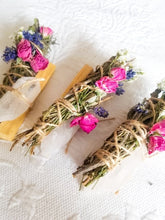 Load image into Gallery viewer, May include: Three bundles of dried herbs and flowers tied with twine, each with a different combination of pink and purple flowers. The bundles are on a white surface.