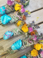 Load image into Gallery viewer, May include: Bundles of dried herbs wrapped in twine, each featuring a bright turquoise stone secured with colored wire. The bundles are decorated with dried yellow roses, pink rosebuds, and sprigs of purple lavender and orange flowers.