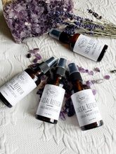 Load image into Gallery viewer, May include: Four amber glass bottles with spray tops and white labels. The labels read "Facial Refresh Lavender Charged Amethyst Crystals 2 oz/59 ml". The bottles are arranged on a white surface with purple amethyst crystals and lavender flowers.