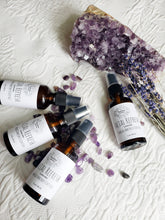 Load image into Gallery viewer, May include: Four amber glass bottles with spray tops filled with lavender facial refresh mist. The bottles are labeled "Facial Refresh Lavender Charged Amethyst Crystals 2 oz / 50 ml". The bottles are arranged on a white surface with purple amethyst crystals and lavender flowers.
