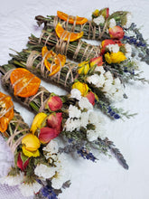 Load image into Gallery viewer, May include: Four bundles of dried herbs and flowers tied with twine. Each bundle includes dried orange slices, white and yellow flowers, and red and yellow roses.
