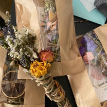 Load image into Gallery viewer, May include: A bundle of dried flowers and herbs wrapped in twine, tied with a brown paper bag. The flowers include lavender, roses, and other dried botanicals. The bag has a label that reads "ROSE QUARTZ"