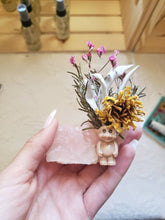 Load image into Gallery viewer, May include: A small pink rose quartz crystal with dried flowers and a small troll figurine on top.