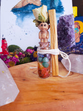 Load image into Gallery viewer, May include: A small glass bottle filled with colorful gemstones, topped with a miniature troll figurine wearing a dried flower crown. A wooden stick is tied to the bottle with twine.