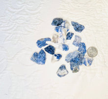 Load image into Gallery viewer, May include: A collection of blue and white tumbled stones, some with a light blue color and others with a darker blue color. The stones are arranged on a white surface.
