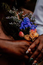 Load image into Gallery viewer, May include: A bouquet of blue and white flowers with dried roses in shades of orange and pink held by two hands with manicured nails.
