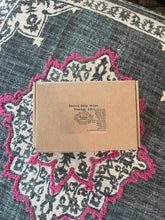 Load image into Gallery viewer, May include: A brown cardboard box with the text "Bestie Baby Witch Starter Kit" printed on the front. The box contains a variety of items for witchcraft, including a candle holder, incense, and intention-setting cards.
