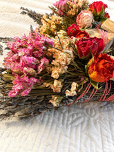 Load image into Gallery viewer, May include: A bundle of dried flowers and herbs tied with pink string, featuring vibrant pink statice, deep red roses, dried lavender stems, and light-colored wood sticks. The arrangement combines various textures and dried botanical elements.
