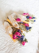 Load image into Gallery viewer, May include: A set of three white crystal wands wrapped in dried flowers and herbs. The wands are tied with twine and the flowers are pink, purple, and white.
