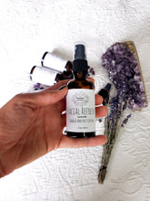 Load image into Gallery viewer, May include: A 2 ounce bottle of facial refresh spray with lavender and charged amethyst crystals. The bottle is brown glass with a black spray top and a white label with black text. The label reads "FACIAL REFRESH Lavender CHARGED AMETHYST CRYSTALS 2 oz / 59 ml".
