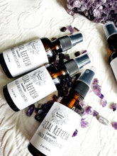 Load image into Gallery viewer, May include: Three amber glass bottles with spray tops and white labels. The labels have black text that reads "Facial Refresh Lavender Charged Amethyst Crystals 2 oz/59 ml". The bottles are surrounded by small purple amethyst crystals.
