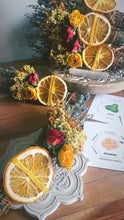 Load image into Gallery viewer, May include: Dried orange slices tied with yellow string, a bouquet of dried flowers, and a card with the words "Orange, Personal Power, Fertility, Harmony, Intuition, Healing, Protection, Luck, Mint" on it.

