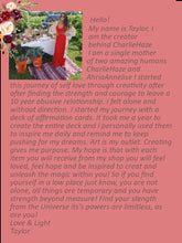 Load image into Gallery viewer, May include: A woman in a red dress stands in front of a table with a sign that reads "Charlie Haze". The text on the sign is a quote about self-love and creativity. The woman is smiling and looking at the camera.
