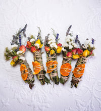Load image into Gallery viewer, May include: Six bundles of dried herbs and flowers tied with twine, each containing dried orange slices, lavender, and other flowers.
