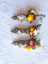 Load image into Gallery viewer, May include: Three bundles of dried flowers and herbs tied with twine and a green stone. The bundles are arranged vertically on a white textured surface.
