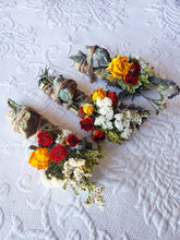 Load image into Gallery viewer, May include: Three bundles of dried flowers and herbs tied with twine and a green stone. The bundles are arranged on a white textured surface. The flowers include white, yellow, and red roses.

