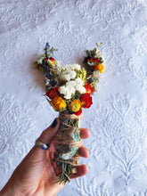Load image into Gallery viewer, May include: A smudge stick with dried flowers and a green stone wrapped in twine. The flowers are white, yellow, orange, and red.

