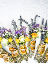 Load image into Gallery viewer, May include: A collection of dried flower bundles with lavender, white and yellow flowers, and dried orange slices. The bundles are tied with twine and are arranged on a white surface.
