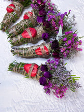 Load image into Gallery viewer, May include: Several bundles of dried herbs and flowers. Each bundle is wrapped with twine and features a dried strawberry slice. Some bundles include purple roses and purple and pink flowers.
