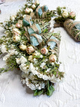 Load image into Gallery viewer, May include: A collection of handmade smudge sticks with dried flowers and green stones. The smudge sticks are tied with twine and feature a variety of dried flowers, including white and pink roses.
